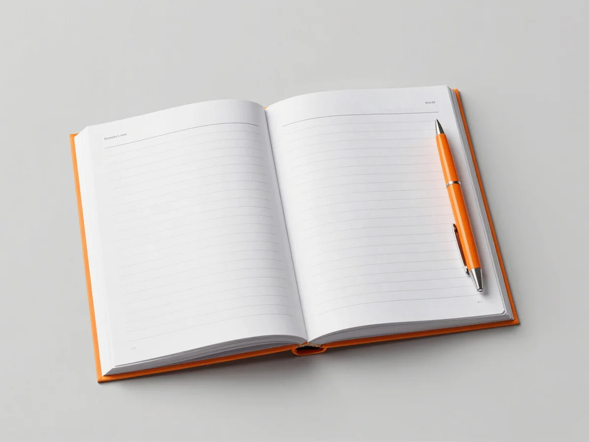 Flat lay of an open book with notes and a pen, bright studio ligh